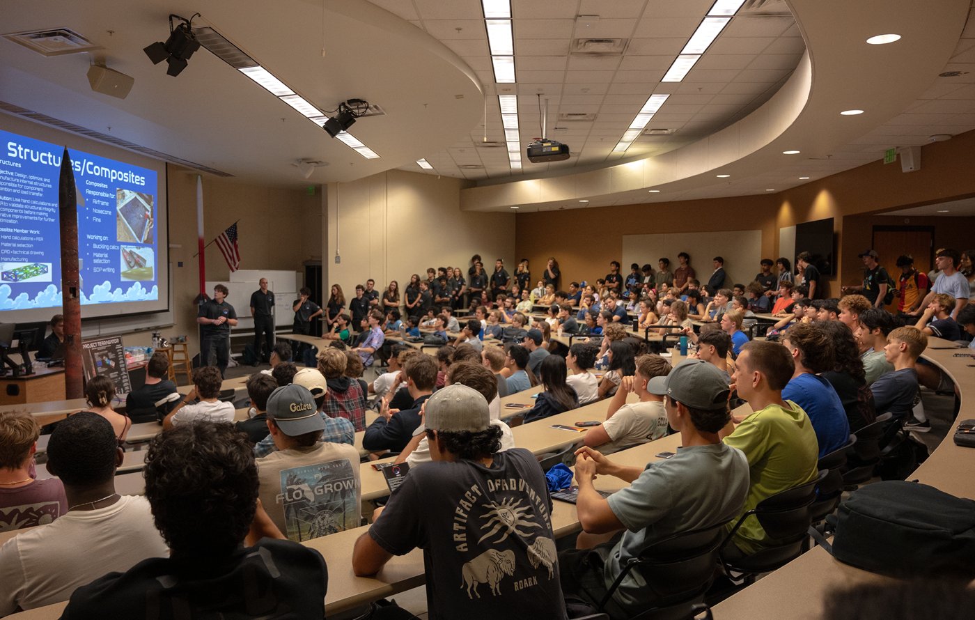 Brett Pavlik lecturing to a full lecture hall at a general body meeting