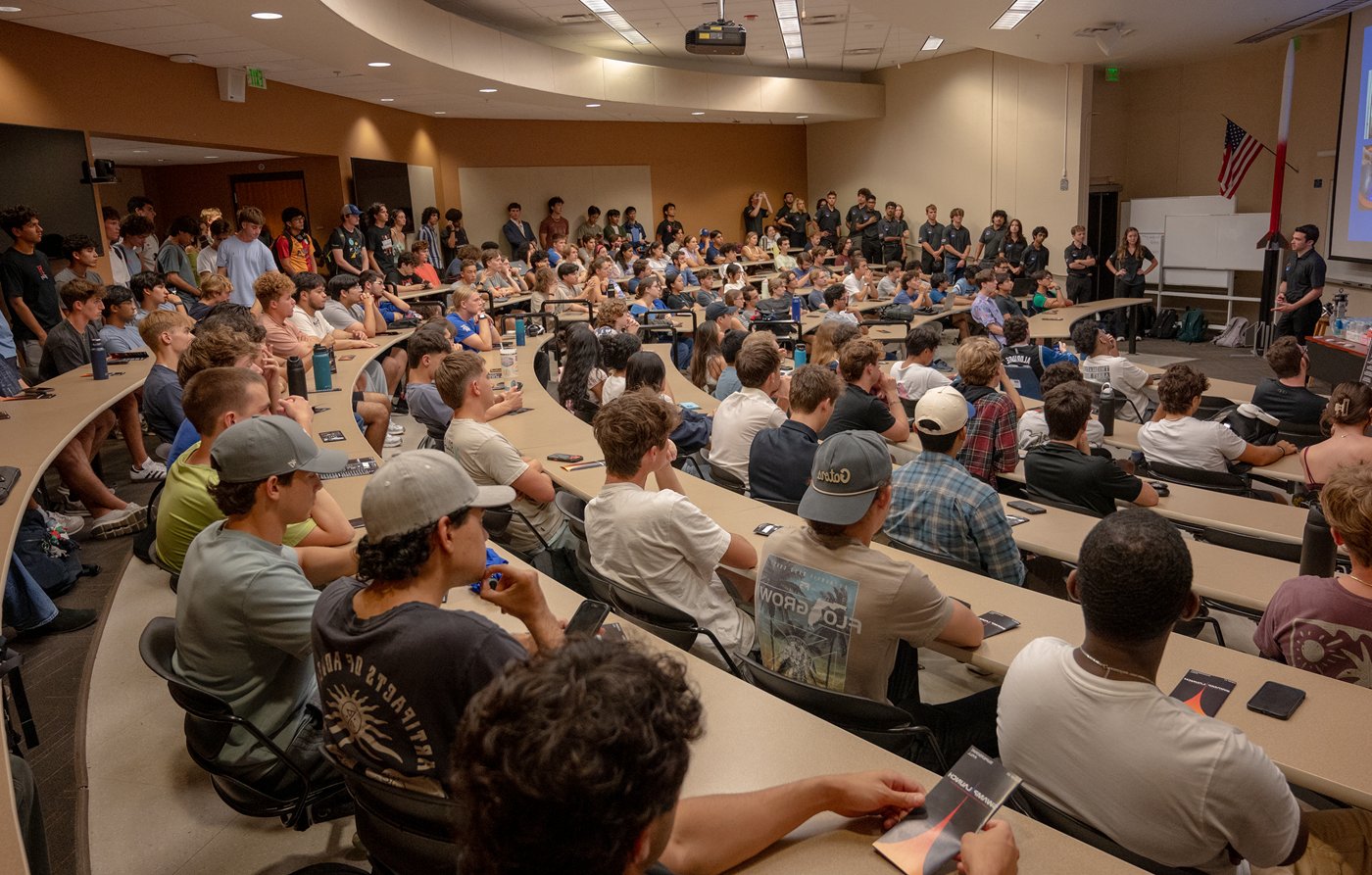 Dylan Jackson presenting to a packed lecture hall