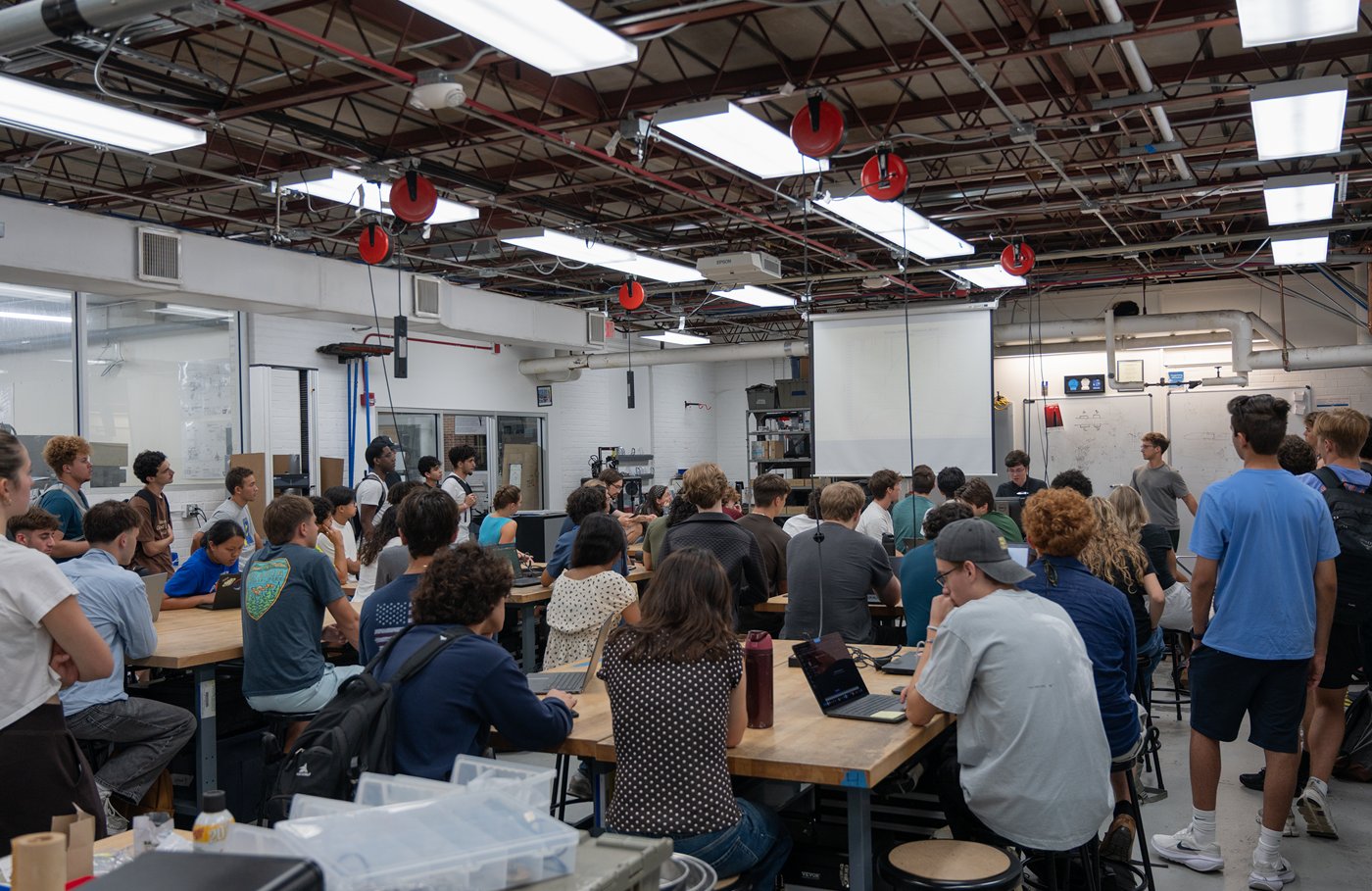Adilkhan Seitov teaching a crowded lab at a GEM