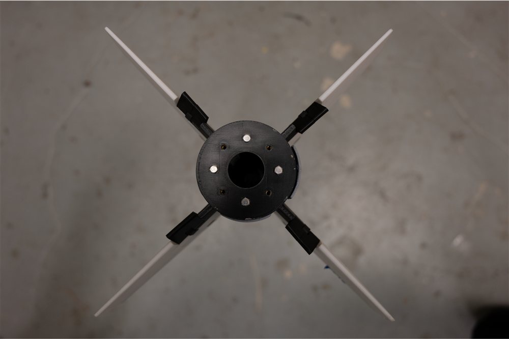 Fin tabs deflected to the left, seen from behind
